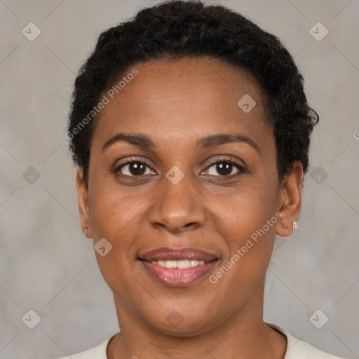 Joyful black adult female with short  brown hair and brown eyes