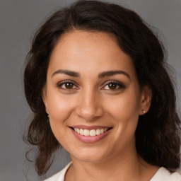 Joyful white young-adult female with medium  brown hair and brown eyes