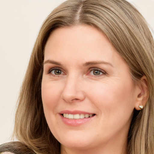 Joyful white adult female with long  brown hair and brown eyes