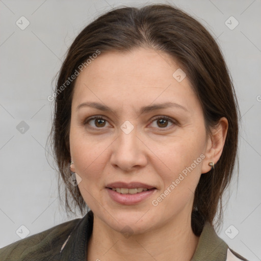 Joyful white adult female with medium  brown hair and grey eyes