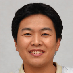 Joyful asian young-adult male with short  black hair and brown eyes