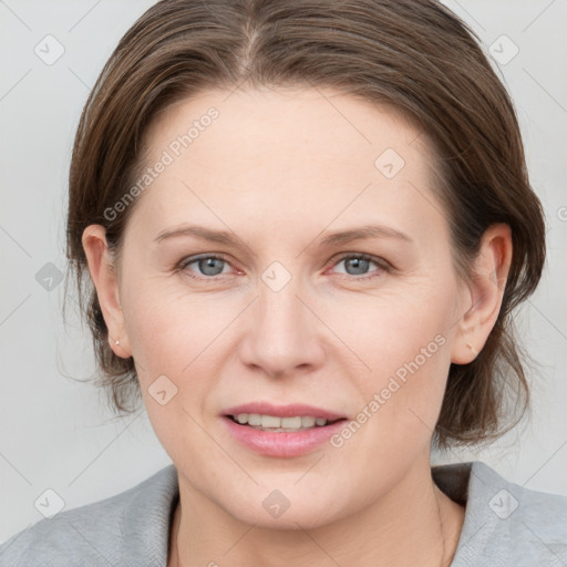 Joyful white young-adult female with medium  brown hair and grey eyes