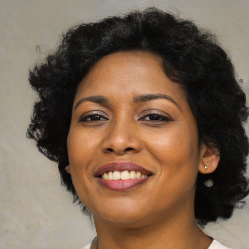 Joyful latino young-adult female with medium  black hair and brown eyes
