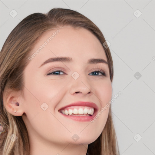 Joyful white young-adult female with long  brown hair and blue eyes