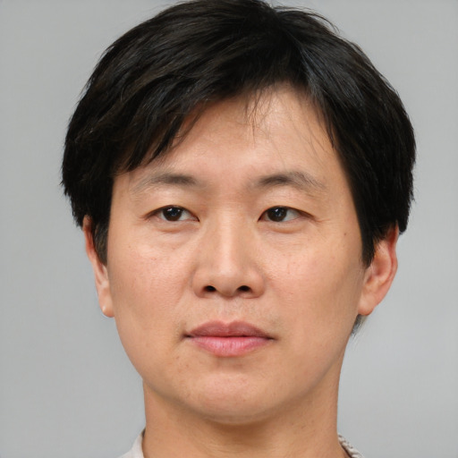 Neutral asian adult male with short  brown hair and brown eyes