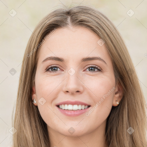 Joyful white young-adult female with long  brown hair and green eyes