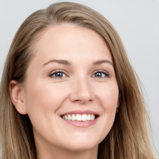 Joyful white young-adult female with long  brown hair and grey eyes