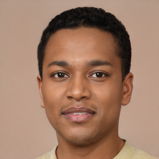 Joyful black young-adult male with short  black hair and brown eyes