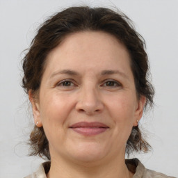 Joyful white adult female with medium  brown hair and brown eyes