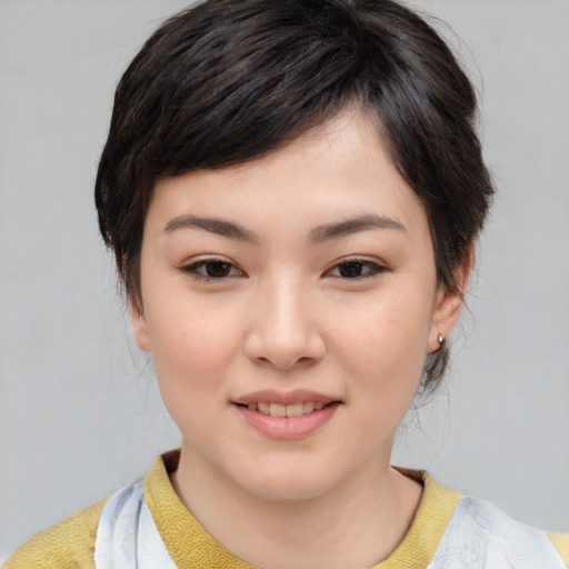 Joyful asian young-adult female with short  brown hair and brown eyes
