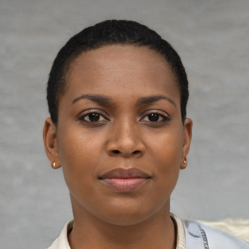 Joyful black young-adult female with short  brown hair and brown eyes