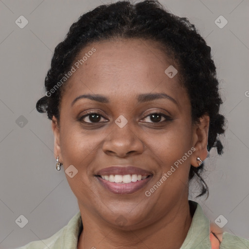 Joyful black adult female with short  brown hair and brown eyes