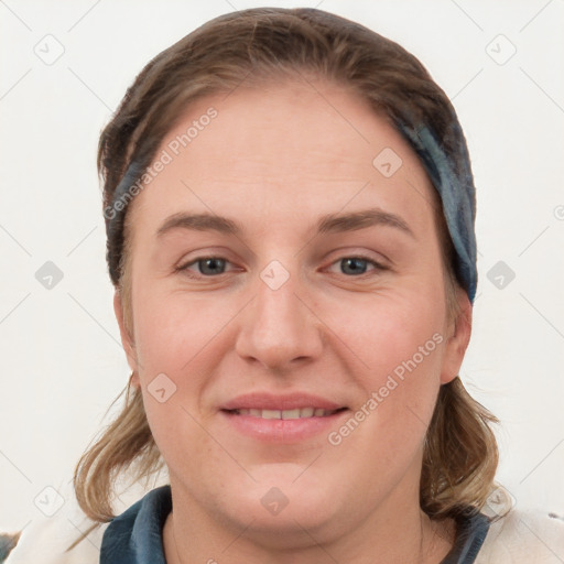 Joyful white young-adult female with medium  brown hair and blue eyes