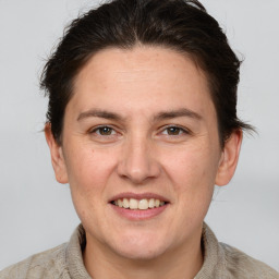 Joyful white adult female with short  brown hair and grey eyes