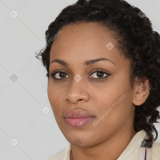 Joyful black young-adult female with long  black hair and brown eyes