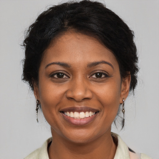 Joyful black young-adult female with medium  brown hair and brown eyes