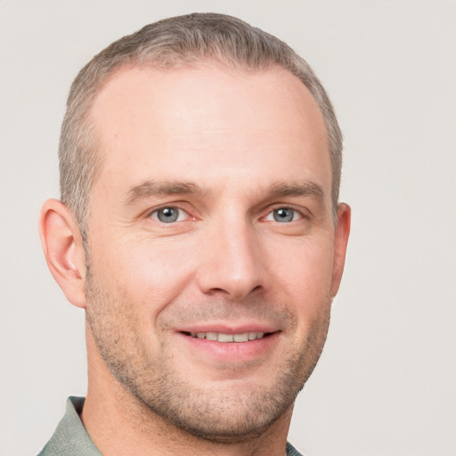 Joyful white adult male with short  brown hair and grey eyes