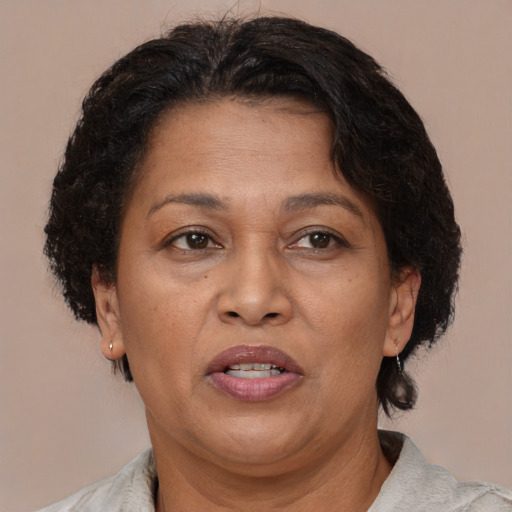 Joyful black adult female with short  brown hair and brown eyes