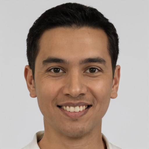 Joyful latino young-adult male with short  black hair and brown eyes