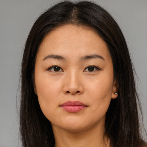 Joyful asian young-adult female with long  brown hair and brown eyes