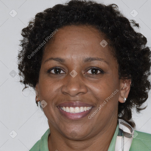 Joyful black adult female with short  brown hair and brown eyes