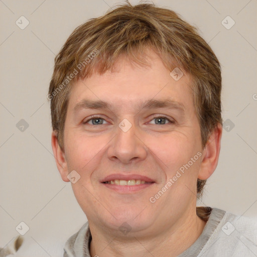 Joyful white adult male with short  brown hair and grey eyes