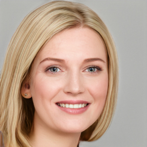 Joyful white young-adult female with long  brown hair and blue eyes