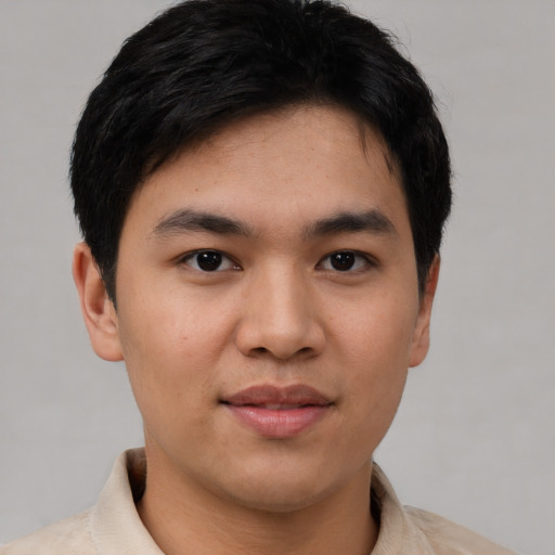 Joyful asian young-adult male with short  brown hair and brown eyes