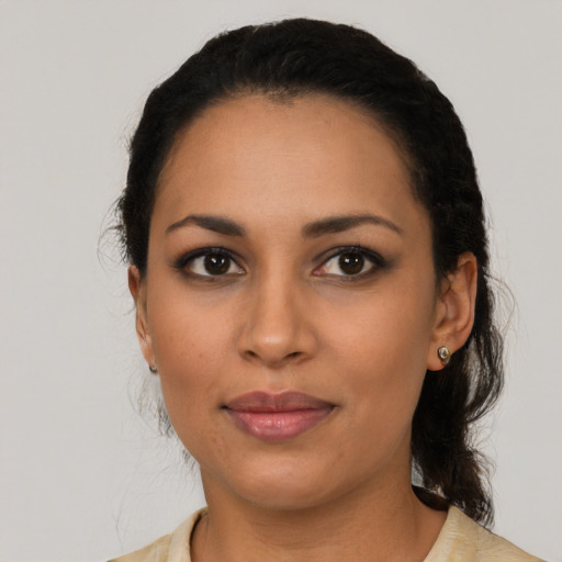 Joyful latino young-adult female with medium  black hair and brown eyes