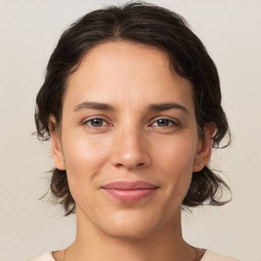 Joyful white young-adult female with medium  brown hair and brown eyes