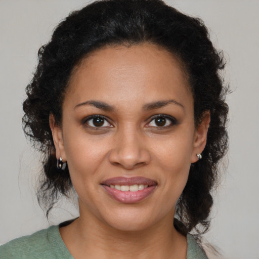 Joyful black young-adult female with medium  brown hair and brown eyes