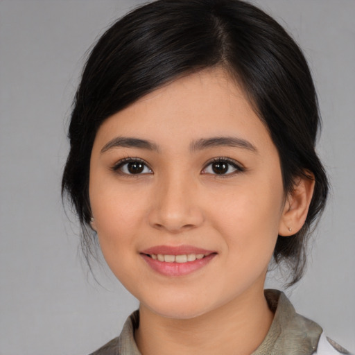 Joyful asian young-adult female with medium  brown hair and brown eyes