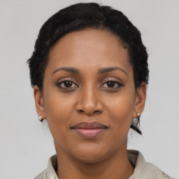 Joyful black young-adult female with short  brown hair and brown eyes