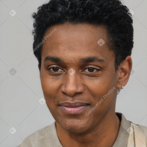 Joyful black young-adult male with short  black hair and brown eyes