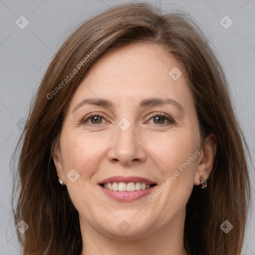 Joyful white adult female with long  brown hair and brown eyes