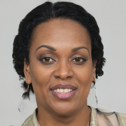 Joyful black adult female with short  brown hair and brown eyes