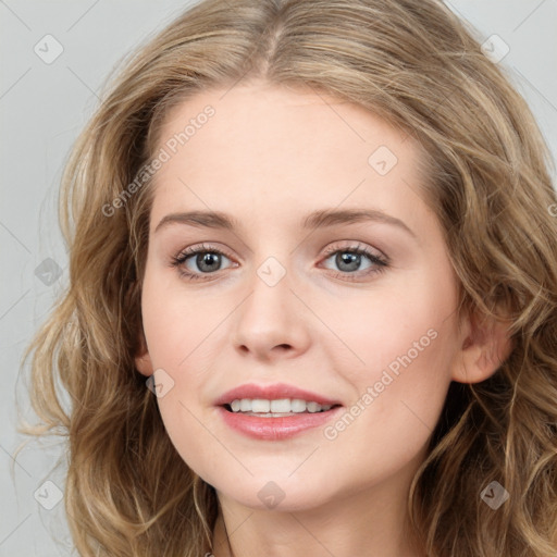 Joyful white young-adult female with long  brown hair and blue eyes