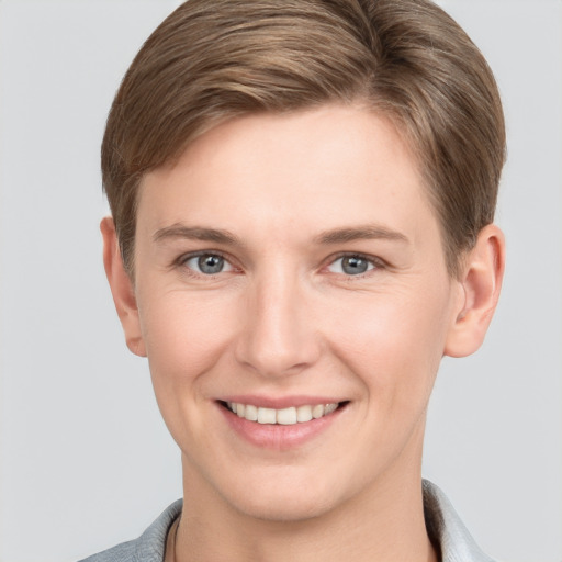 Joyful white young-adult female with short  brown hair and grey eyes