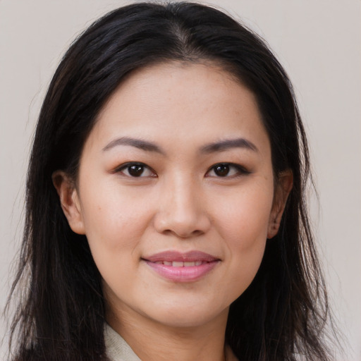 Joyful asian young-adult female with long  brown hair and brown eyes