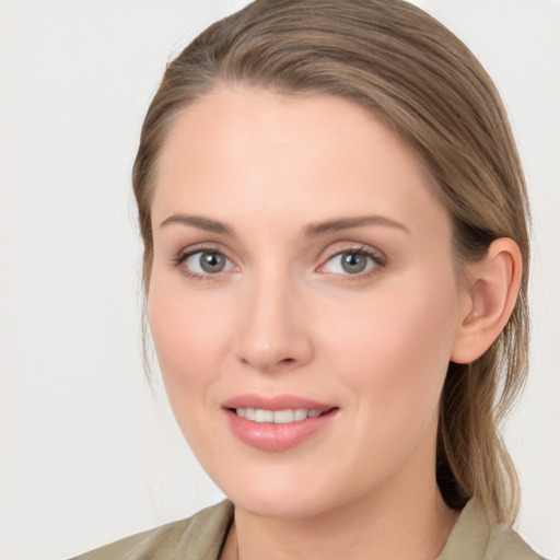 Joyful white young-adult female with medium  brown hair and blue eyes