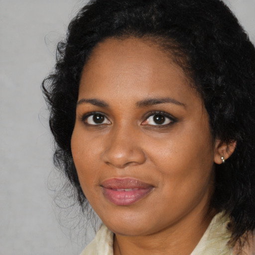Joyful black adult female with medium  black hair and brown eyes