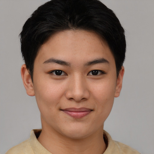 Joyful asian young-adult female with short  brown hair and brown eyes