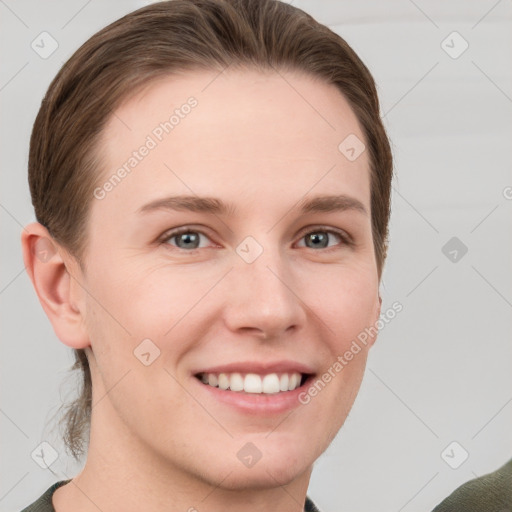 Joyful white young-adult female with short  brown hair and grey eyes