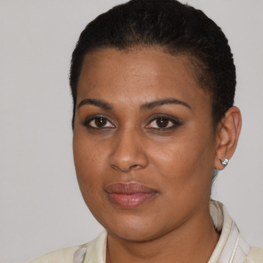 Joyful black young-adult female with short  brown hair and brown eyes