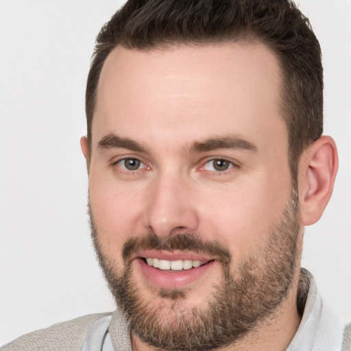 Joyful white young-adult male with short  brown hair and brown eyes