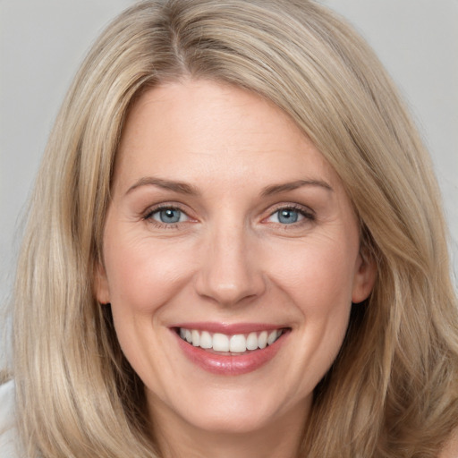 Joyful white adult female with long  brown hair and grey eyes