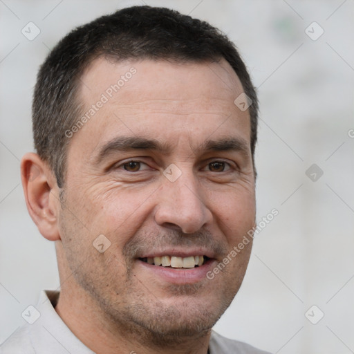 Joyful white adult male with short  brown hair and brown eyes