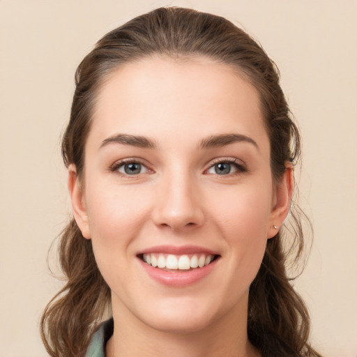 Joyful white young-adult female with long  brown hair and grey eyes