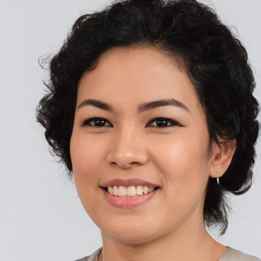Joyful asian young-adult female with medium  black hair and brown eyes