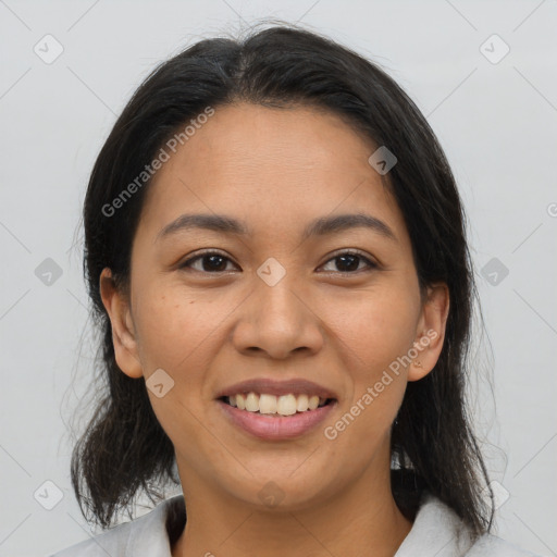 Joyful latino young-adult female with medium  brown hair and brown eyes